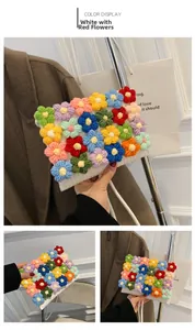Detail of handmade knit bag showing colorful floral patterns and white woven strap