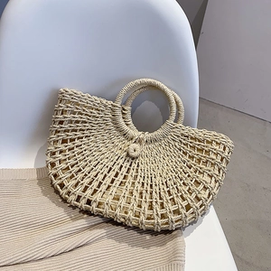 Minimalist straw half-moon handbag with circular handles for summer beach vacation