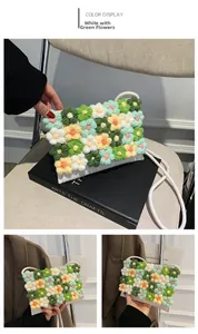 Detail of handmade crochet crossbody bag featuring 3D floral knit patterns in white and green