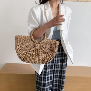 Handmade hollow mesh straw tote bag with round handle for summer beach vacations