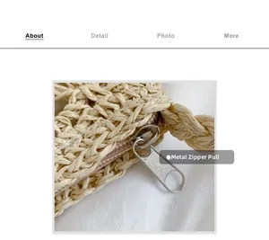 Detailed macro view of the silver hardware zipper on a beige straw woven beach bag
