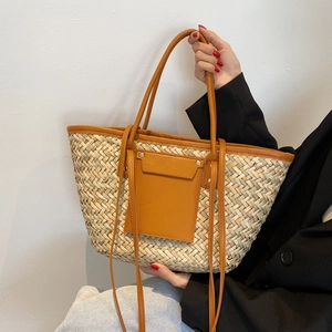 Retro woven straw tote bag with brown leather handles and decorative front pocket