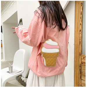 Girl wearing a creative ice cream shaped crossbody bag with gold chain strap detail
