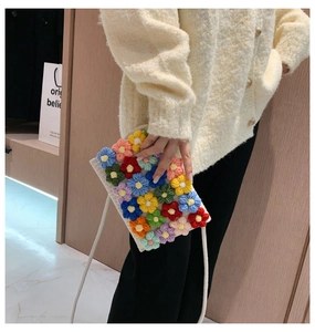 Handmade crochet mini crossbody bag featuring vibrant colorful 3D floral patterns