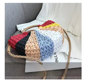Detail view of multicolored woven paper rope beach bag with vibrant block pattern