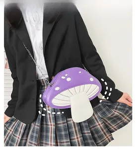 Girl wearing a purple mushroom-shaped crossbody bag with white dots and chain strap