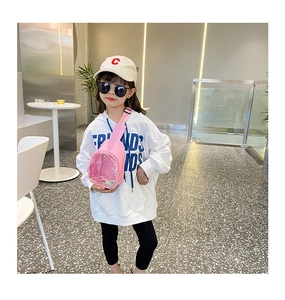 Pink PVC chest bag for kids with colorful glitter and adjustable strap shown on model