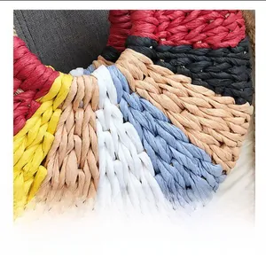 Macro detail of multi-color woven straw bag showing the intricate handmade texture