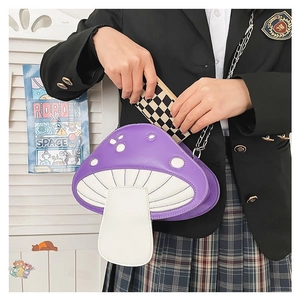 Detail of purple mushroom crossbody bag with white dots and metal chain strap