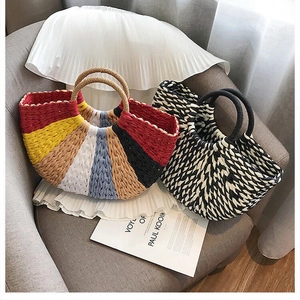 Detail of colorful striped and black-white woven handbags on a soft sofa