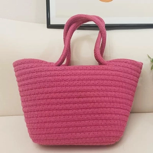 Detailed view of the rose red woven cotton rope tote bag with thick texture