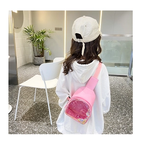 Pink PVC chest bag for kids featuring a transparent pocket filled with colorful sequins