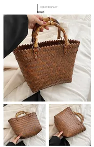 Detail of hand-woven brown leather tote with natural bamboo handles and vintage hardware