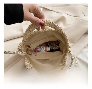 Detail view of the spacious inner compartment with a zipper pocket in this straw bag