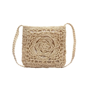 Handcrafted bohemian straw crossbody bag with floral pattern for summer beach vacations