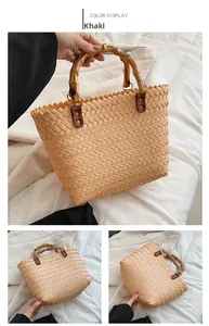 Detail of khaki woven straw bag featuring bamboo handle and secure metal fasteners