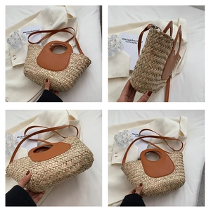 Detail of woven straw bucket bag showing leather ring handle and natural plant fiber texture