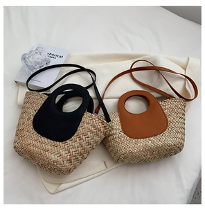 Detail of handwoven straw tote bags with leather trim in black and brown finishes