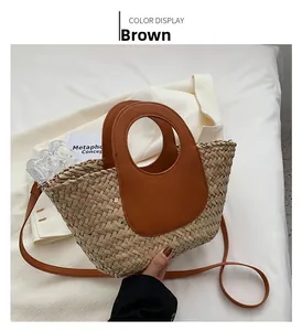 Detail shot of handwoven straw bucket bag with premium brown leather strap and handle