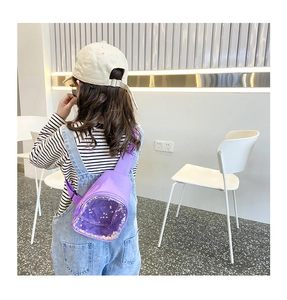 Detail view of purple children PVC chest bag with colorful sequins on a young model