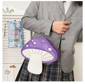 Detail view of the zipper closure on the mushroom-shaped crossbody bag with chain strap