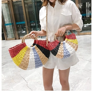 Colorful woven bohemian straw handbag with semi-circular shape and round handles