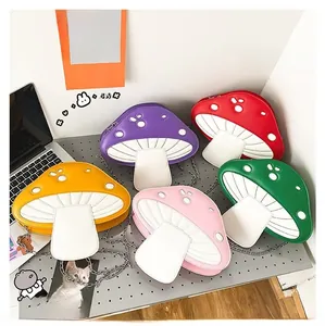 Flat lay of colorful mushroom-shaped crossbody bags with chain straps in five vibrant colors