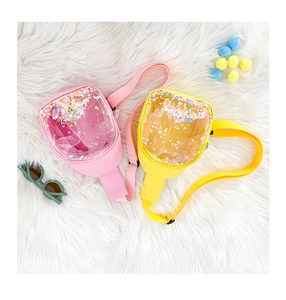 Detail of pink and yellow kids' PVC chest bags with colorful glitter and sequins