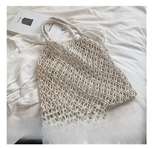 Close-up of the hollow mesh woven tote bag showing its intricate bohemian texture