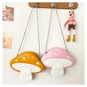 Detail of mushroom cross body bags with contrast stitching and silver metal chain strap