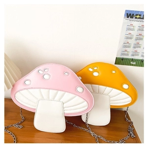 Detail of pink and yellow mushroom crossbody bags with quilted texture and chain straps