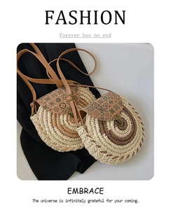 Detail of round straw crossbody bag featuring woven texture and cork print flap cover