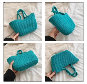 Detail of teal woven cotton rope handbag with textured pattern and round top handles