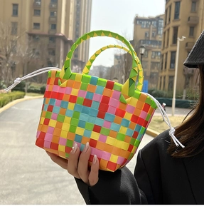 Borsa da spiaggia intrecciata arcobaleno con coulisse bianca scattata all'aperto