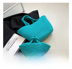Detail view of turquoise woven cotton rope tote and handbag with textured knit patterns