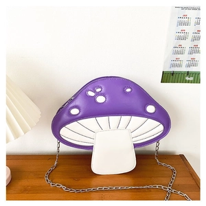 Detail of mushroom crossbody bag with purple polka dots and silver metal chain strap