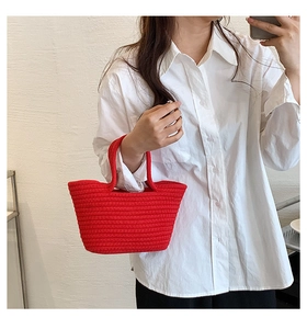 Close-up of vibrant red cotton rope woven handbag with textured spiral pattern