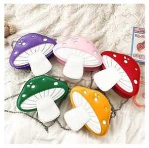 Flat lay of colorful mushroom crossbody bags in five vibrant shades with chain straps