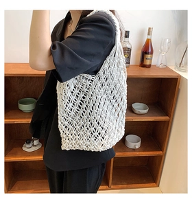 Detailed view of the white handmade woven shoulder bag with bohemian hollow circular knots