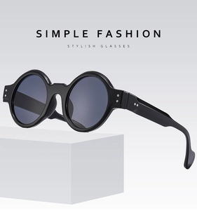 Detail of classic black round punk sunglasses featuring silver rivet studs and wide temples