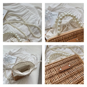 Detail view of woven straw beach bag with pearl handle, chain strap, and drawstring liner