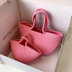 Detailed view of pink woven cotton rope bags in two sizes inside a gift box