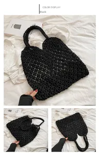 Detail view of black hollow mesh hand-woven beach bag with diamond knot patterns