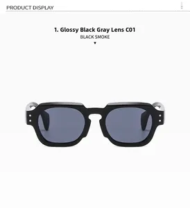 Detail of glossy black square sunglasses with smoke lenses and metal rivet accents