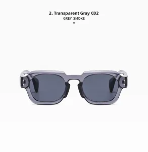 Close-up of transparent grey square frame sunglasses featuring metallic dot rivets