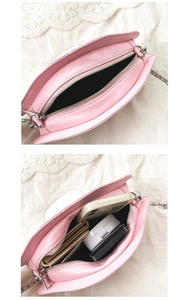Internal view of pink mushroom crossbody bag with chain strap and essential compartments