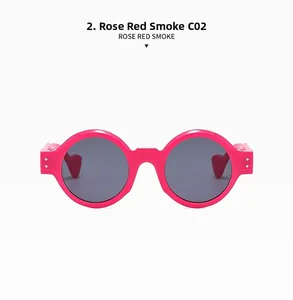 Close-up of rose red punk sunglasses with silver rivets and grey smoke lenses