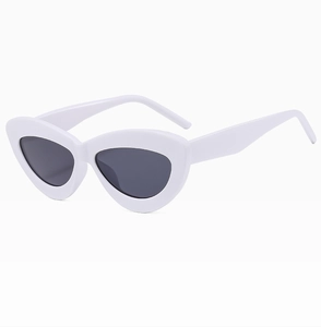Detailed view of vintage cat-eye sunglasses with white frames and dark lenses