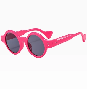 Detail of rose red round sunglasses featuring silver rivets and wavy heart-shaped temples