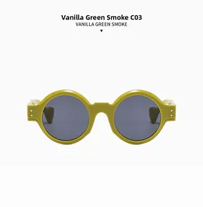 Close-up of retro round C03 sunglasses in vanilla green frame with smoke lenses